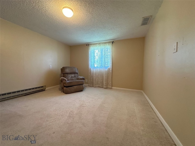 unfurnished room with carpet, a textured ceiling, and a baseboard heating unit