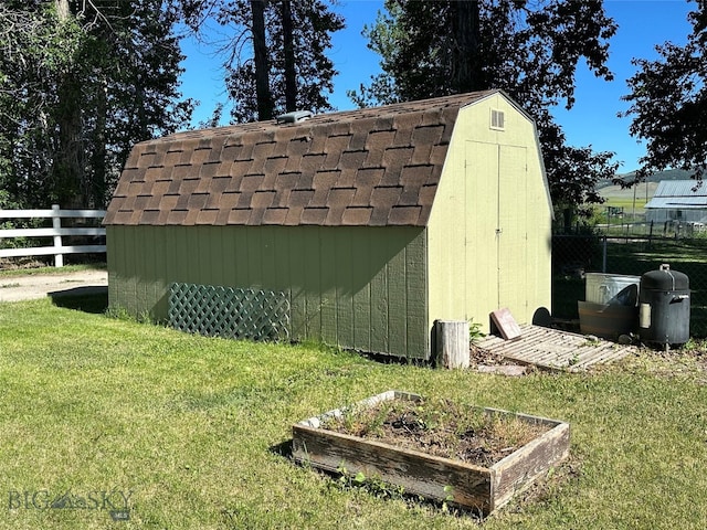 view of outbuilding with a yard