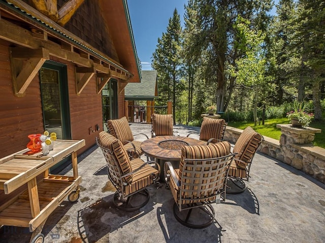 view of patio / terrace featuring an outdoor fire pit