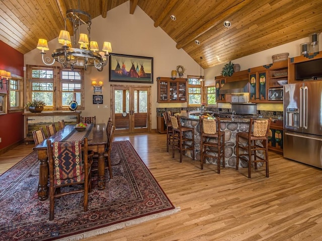 dining area featuring french doors, wood ceiling, a chandelier, and light hardwood / wood-style flooring