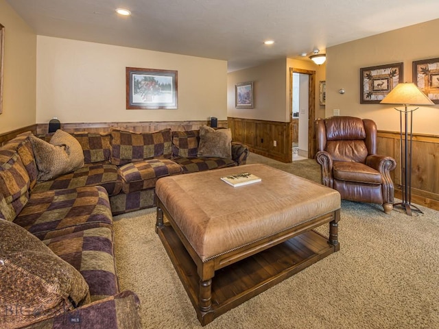 carpeted living room featuring wooden walls