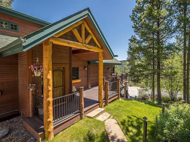 exterior space featuring a wooden deck and a yard