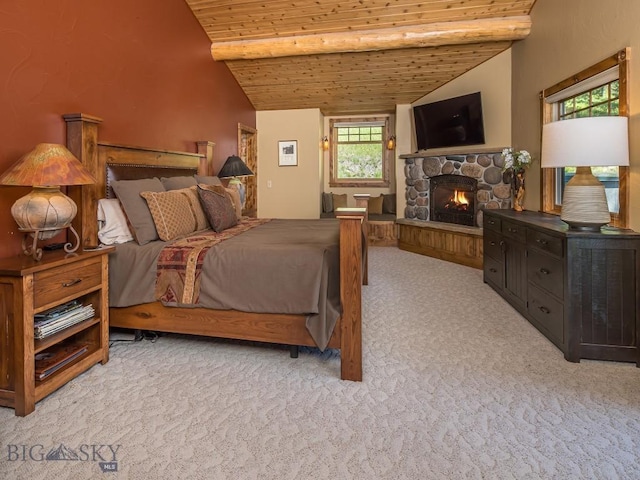 bedroom with vaulted ceiling with beams, light colored carpet, a fireplace, and wooden ceiling