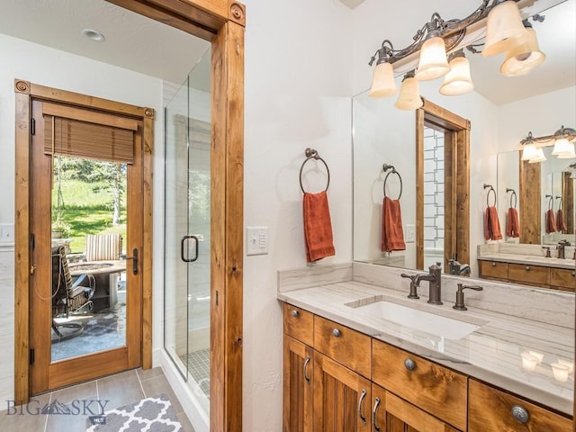 bathroom with tile patterned floors, vanity, and an enclosed shower