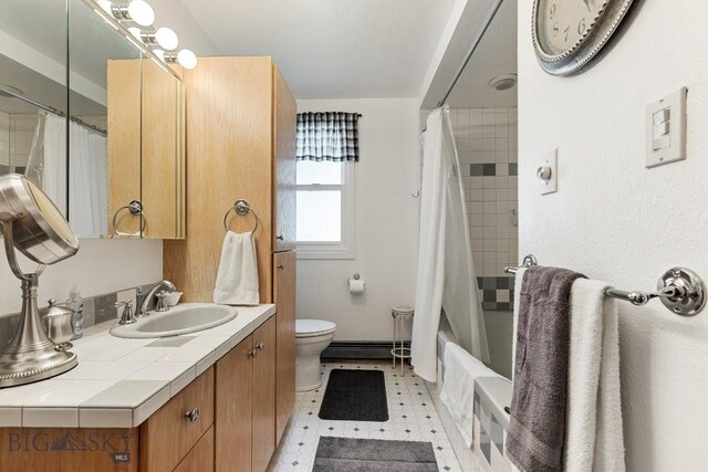 full bathroom featuring shower / bath combo, baseboard heating, tile floors, toilet, and vanity