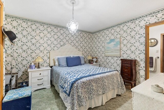 carpeted bedroom featuring an inviting chandelier