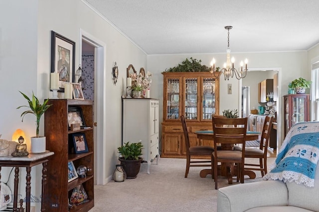 dining room featuring light carpet, a chandelier, and ornamental molding