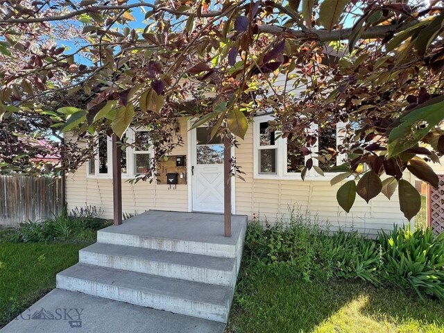 doorway to property featuring a yard