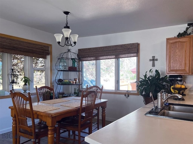 dining space with a chandelier and sink