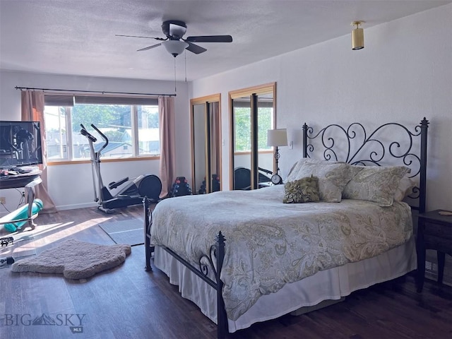bedroom featuring dark wood-type flooring and ceiling fan
