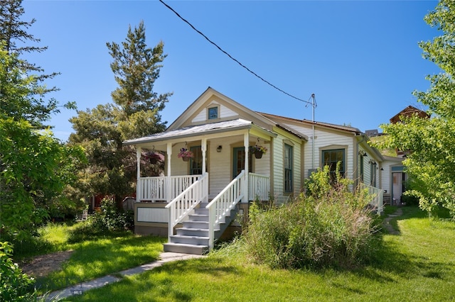 view of front of house with covered porch and a front yard