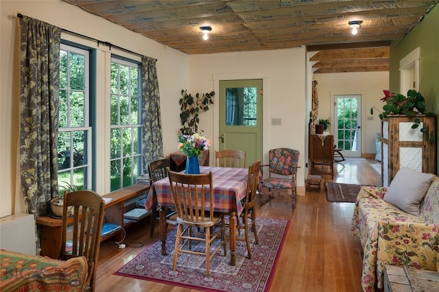 dining space with wooden ceiling and light hardwood / wood-style flooring