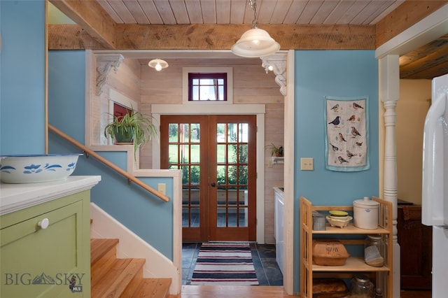 foyer with beam ceiling, french doors, and wooden ceiling