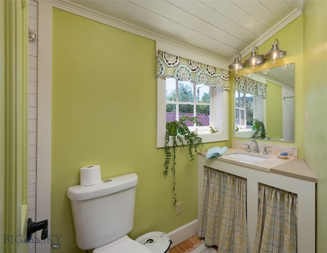 bathroom with wood-type flooring, ornamental molding, vanity, and toilet