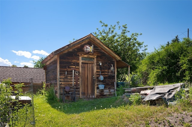 view of outbuilding featuring a lawn