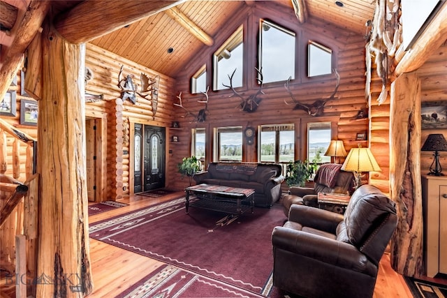 living room with log walls, beam ceiling, high vaulted ceiling, wooden ceiling, and wood-type flooring