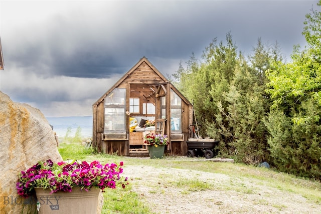 back of property featuring a water view