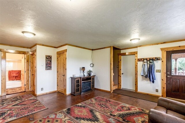 living room with a textured ceiling and crown molding