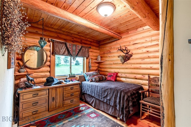 bedroom with wooden ceiling, hardwood / wood-style floors, beam ceiling, and log walls