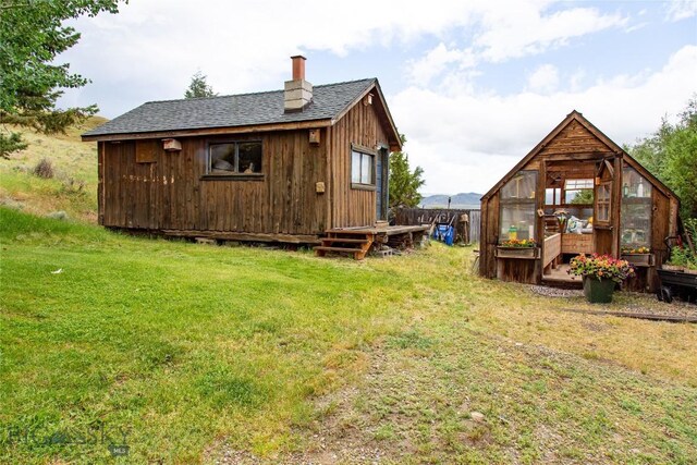 rear view of property featuring a yard