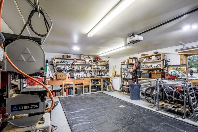 garage featuring a garage door opener and a workshop area