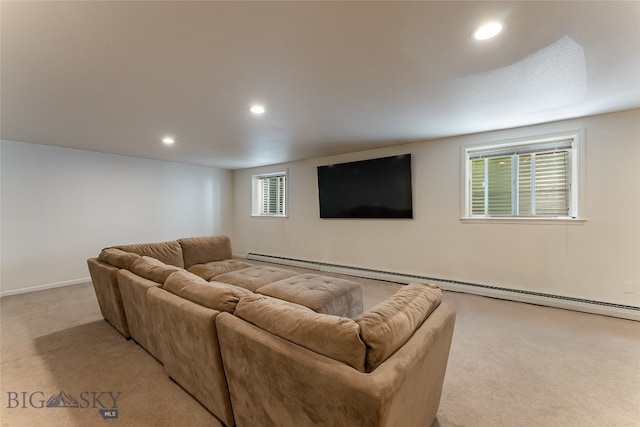 carpeted living room featuring a baseboard heating unit and plenty of natural light