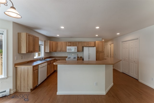 kitchen with a center island, light wood-type flooring, and white appliances