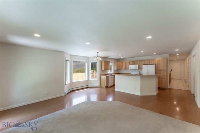 unfurnished living room featuring light tile patterned flooring, a notable chandelier, and a baseboard radiator