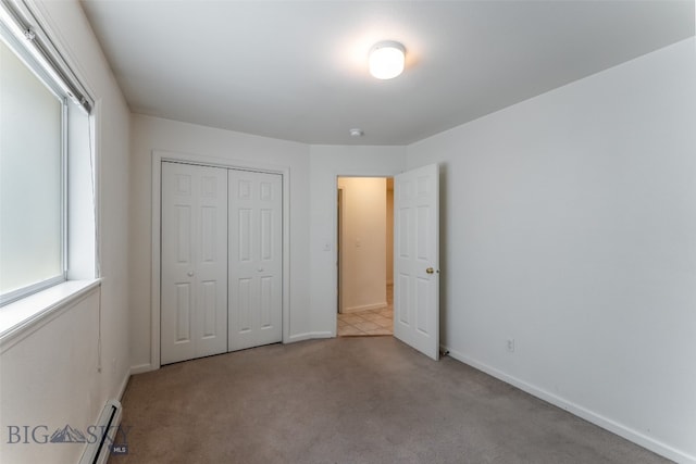 unfurnished bedroom with carpet and a closet