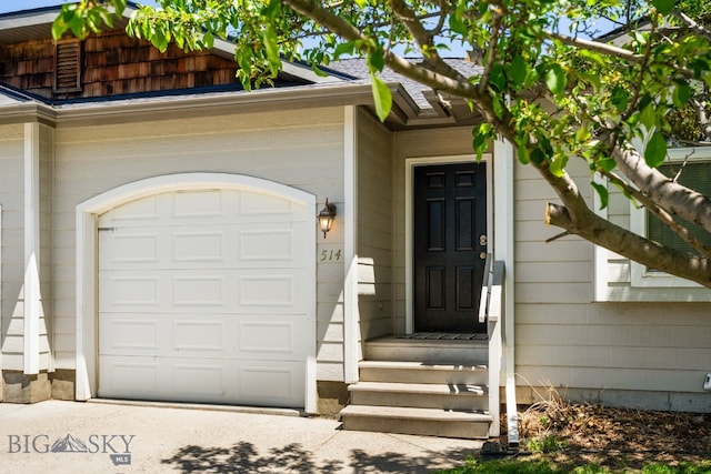 doorway to property with a garage