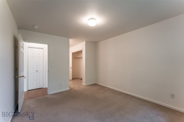 unfurnished bedroom featuring carpet and a closet