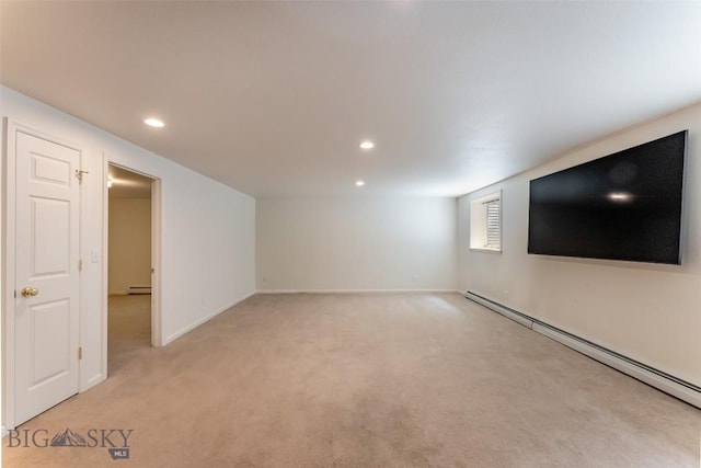 below grade area with recessed lighting, baseboards, a baseboard heating unit, and light carpet