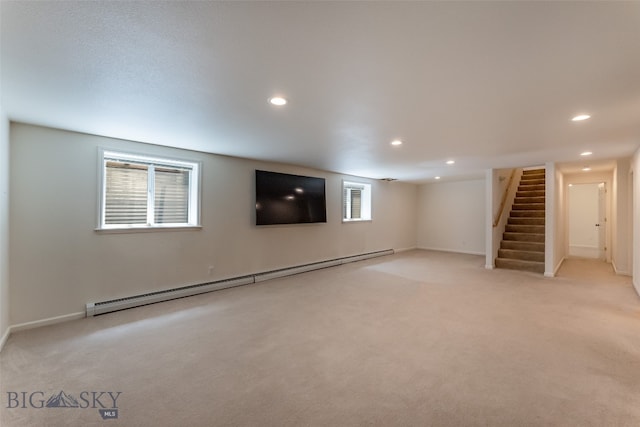 basement featuring light carpet and a baseboard radiator