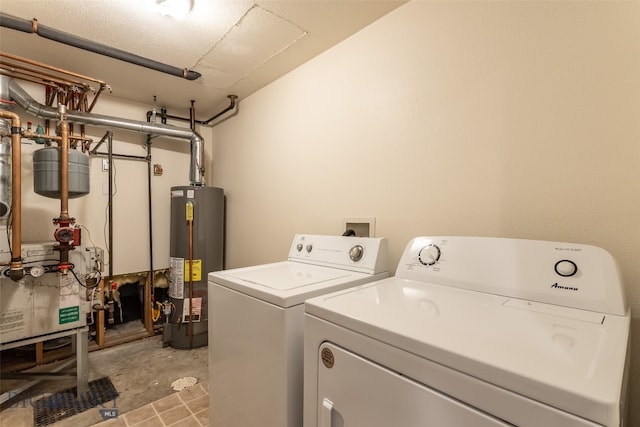 washroom featuring washing machine and clothes dryer and water heater