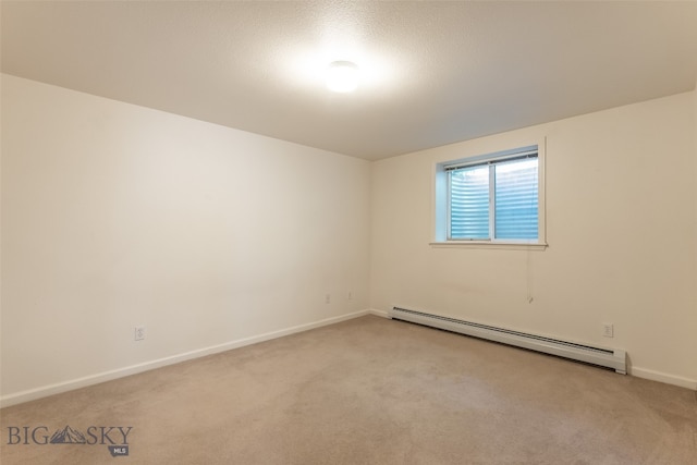 carpeted empty room featuring a baseboard radiator