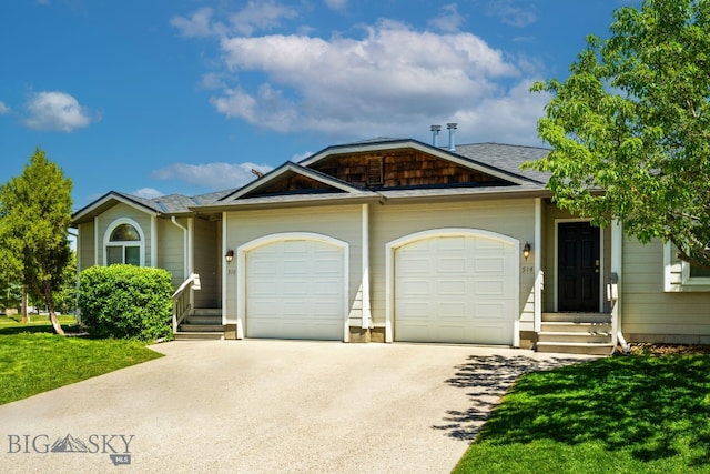 view of front of house with a garage and a front yard