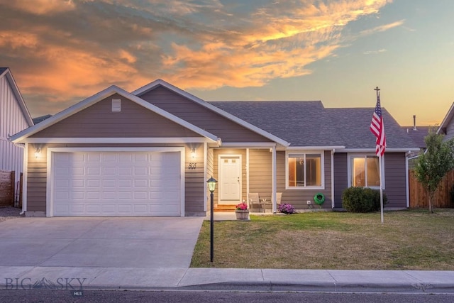 view of front of property with a lawn and a garage