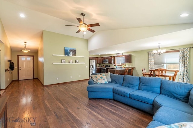 living room with ceiling fan with notable chandelier, dark wood-type flooring, and vaulted ceiling