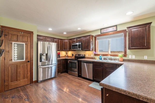 kitchen featuring dark hardwood / wood-style floors, dark brown cabinets, sink, and appliances with stainless steel finishes