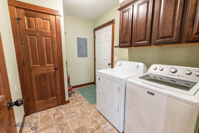 clothes washing area featuring cabinets, washing machine and dryer, and electric panel