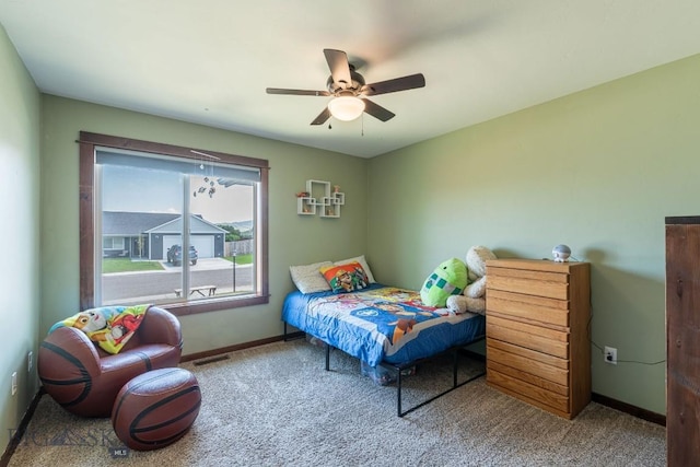 bedroom featuring ceiling fan and carpet