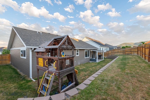 back of house with a lawn