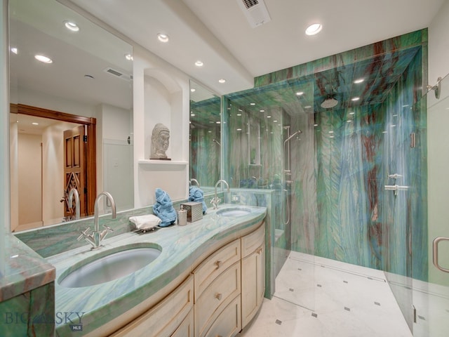 bathroom featuring walk in shower, tile patterned flooring, and dual vanity