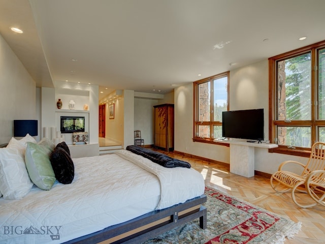 bedroom featuring light parquet floors and multiple windows