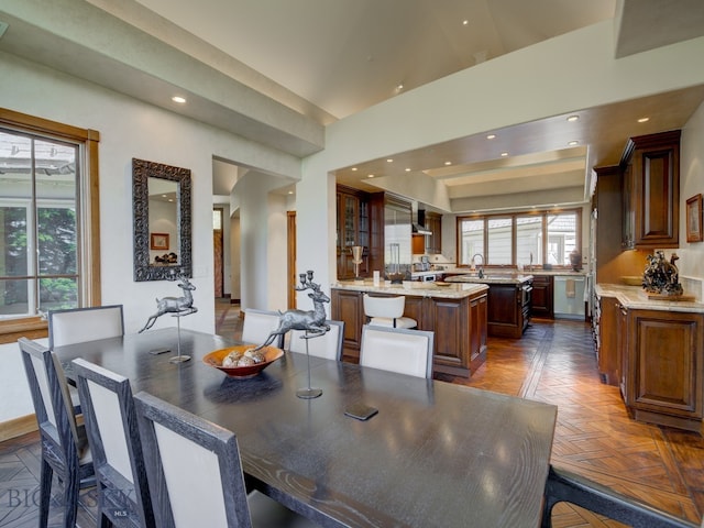 dining room featuring parquet flooring and a wealth of natural light