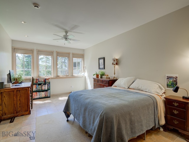 tiled bedroom featuring ceiling fan