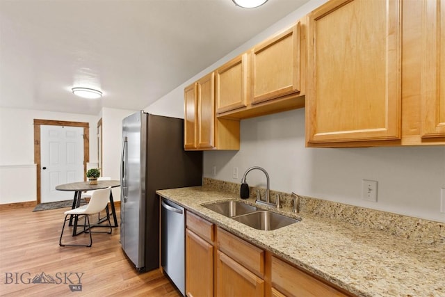 kitchen featuring light hardwood / wood-style floors, light brown cabinetry, dishwasher, and sink