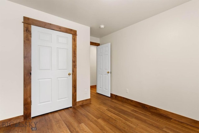 unfurnished bedroom featuring hardwood / wood-style flooring