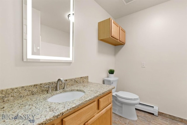 bathroom with vanity, toilet, and baseboard heating