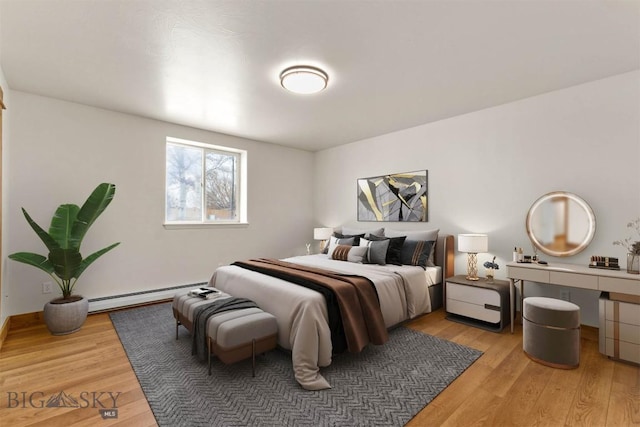 bedroom featuring a baseboard radiator and hardwood / wood-style floors